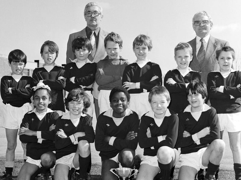 Iain Pearson identified this team as Kingswood Junior School 'A' Team from Corby in 1984 - The two adults being Mr Green (Headmaster) and Mr Thomas (Sports)
He recognised David Winter, Shaun Fisher (goalkeeper), Stephen Cairns Shaun Fisher, Craig Fisher, Andre Bonner Andy McShane and Gurdip Singh
