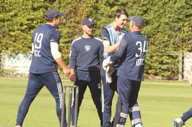 Desborough celebrate a wicket during their win against Overstone, which secured their Premier Division status. Pictures by Finbarr Carroll