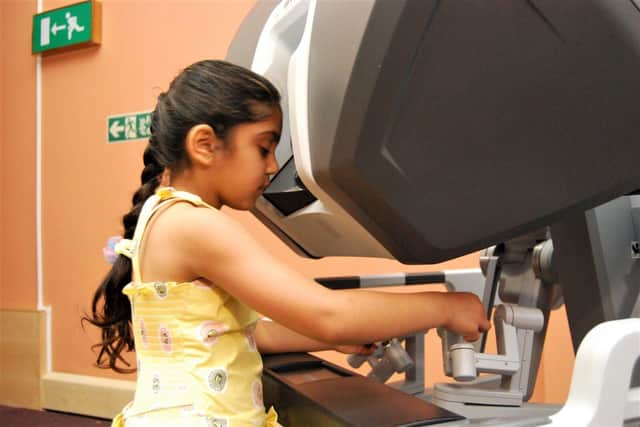 •	Saee, six, playing on the demonstration robot.