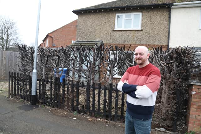 Matthew Busby with the remains of the hedge that he believes was set alight by a sparking lamppost as witnessed by his neighbours/National World