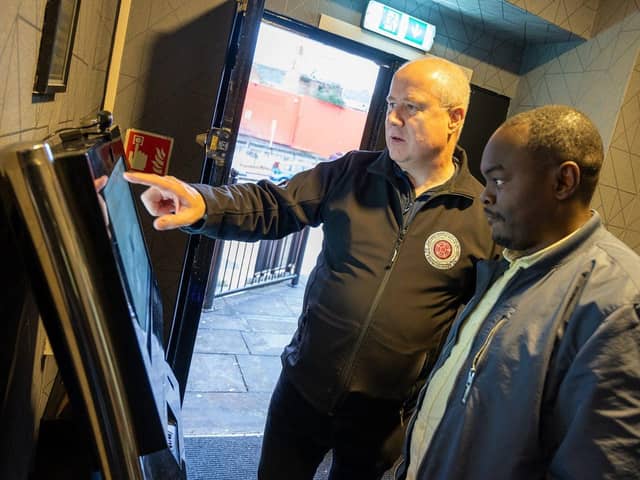 Stephen Mold is shown the new ID scanning technology by Danny Kituno, owner of Escape in Northampton
