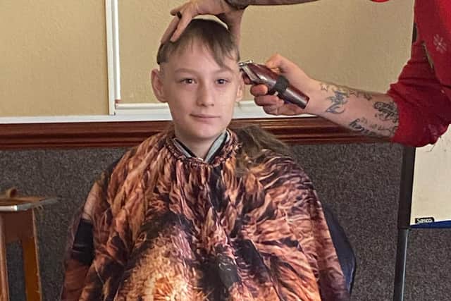 Tyler has his shoulder-length hair trimmed/UGC