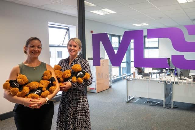 Emily (L) and Nicola (R) present the bears at MDS' office