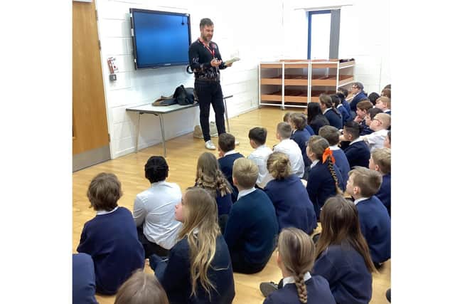 Writer Ben Davis talks to pupils at Hayfield Cross /Hayfield Cross Primary School