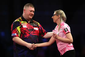 Ricky Evans congratulates Fallon Sherrock on her performance in their first round match of the Cazoo World Darts Championship at Alexandra Palace on Tuesday night