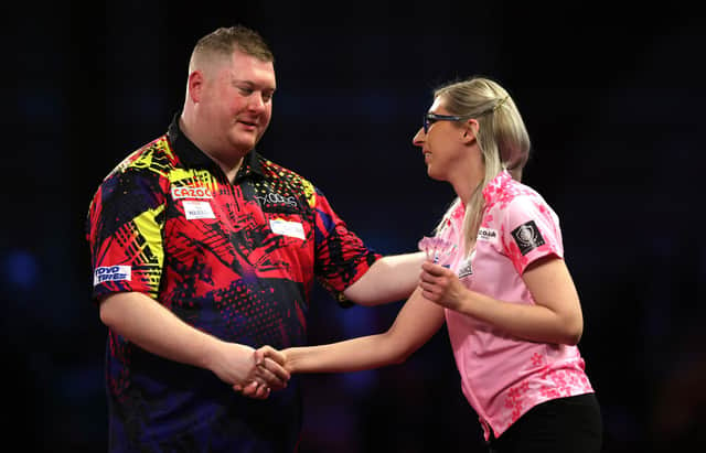 Ricky Evans congratulates Fallon Sherrock on her performance in their first round match of the Cazoo World Darts Championship at Alexandra Palace on Tuesday night