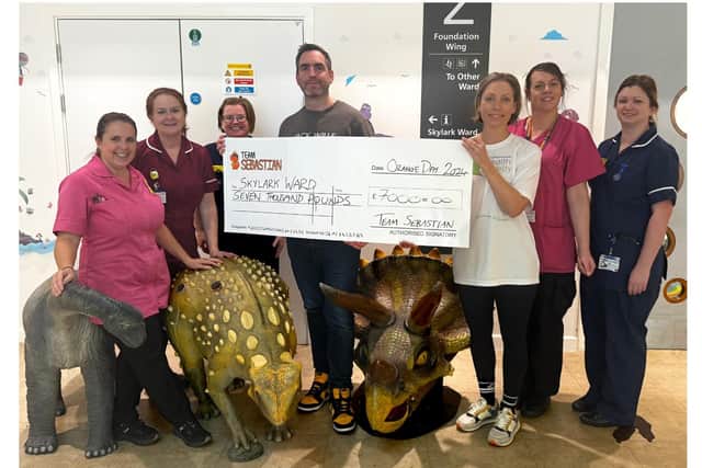 Gregg Nunney hands over the donation to Team Sebastian/Team Sebastian