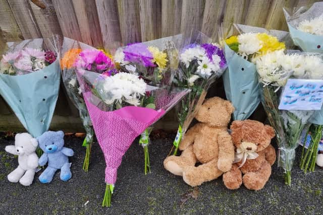 Teddy bears and flowers left at the scene of the triple murder at Petherton Court, Kettering