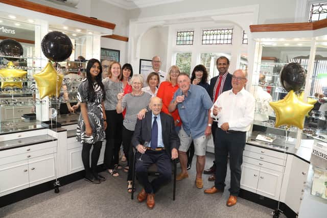 Partners and staff of Davis Optometrist, independent opticians, celebrate the 60th anniversary of the Kettering business with founder Rodney Davis (seated)