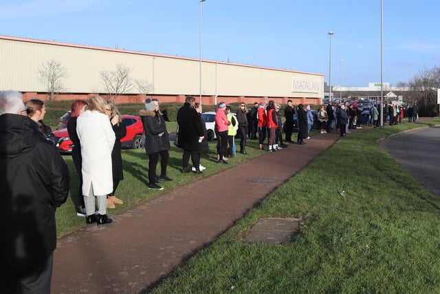 People line the street outside Corby fire station