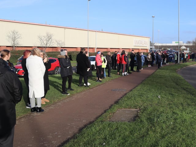 People line the street outside Corby fire station