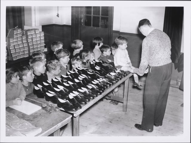 Free Shoes for the Evacuees, Evacuees being fitted with shoes donated by a local brick manufacturing firm at Bletchley near Northampton, Bletchley. (Photo by Hulton Archive/Getty Images)