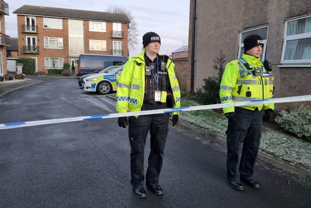 Police officers at the scene of the incident, Petherton Court, Kettering, on Friday (December 16).