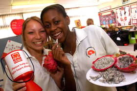 Jessica Taylor and Simone Remba, both 14, try out a dragon fruit for Healthy Heart Week