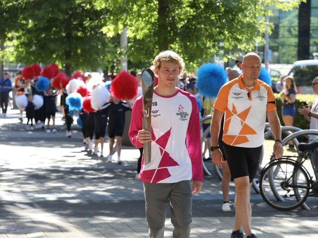 Archie Evans walked with the baton to the pool