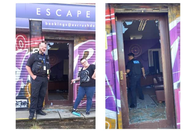 Leigha Stuart gives a wry smile outside the Escape Rooms as a police officer stands next to the damaged door