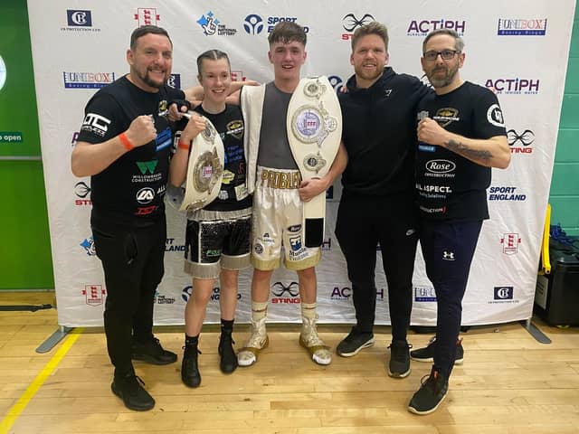 Lauren Mackie, Ellis Panter and their coaching team pose for the camera after their national title successes in Solihull