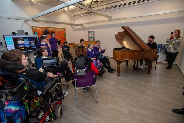 Billy Lockett visiting Greenfields Specialist School For Communication to donate the piano he wrote his debut album on. Photo by David Jackson.
