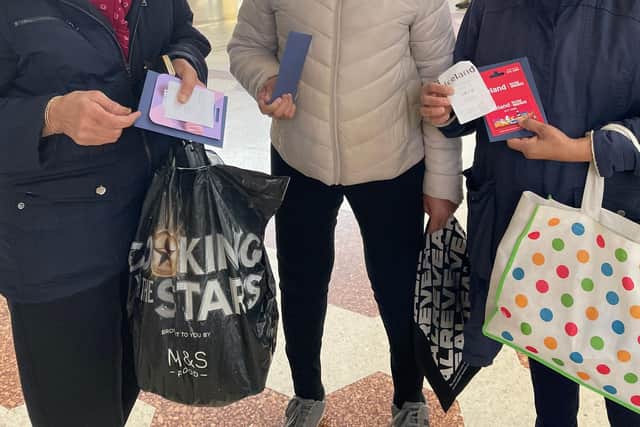 Customers at Swansgate Shopping Centre, with gift cards received from Swansgate Shopping Centre.