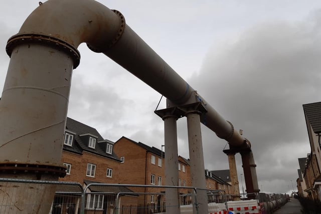 The pipe is raised in some places and is directly opposite a row of houses on the Stanton Cross estate