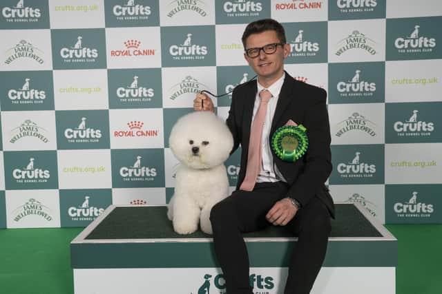 Rich Smith from Kettering with Ronnie, a Bichon Frise, which was the Best of Breed winner today (Friday 07.03.25), the second day of Crufts 2025 (Pic credit: BeatMedia/The Royal Kennel Club)