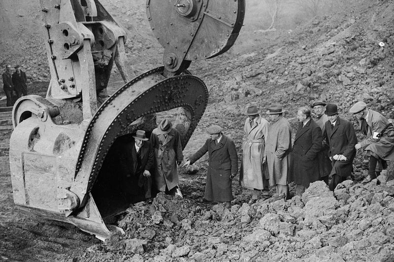 Men emerge from the fifteen ton scoop of Europe's biggest digger at Corby on 2nd November 1934.