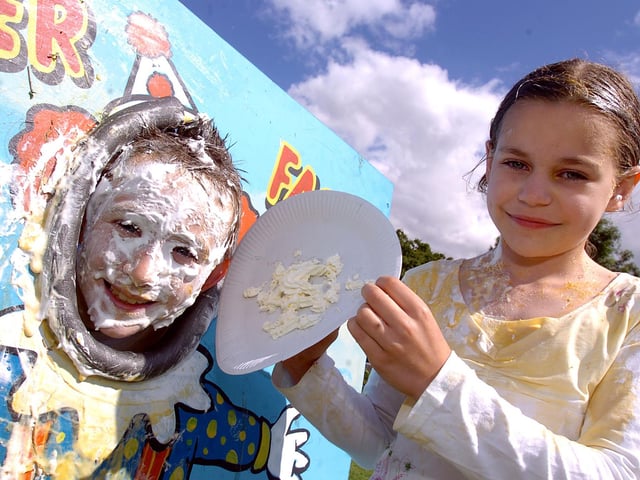 Josh Gardiner, nine, gets a face full of cream and custard from Maddie Coomar, 10, July 2008