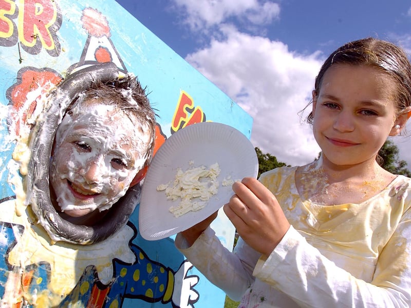 Josh Gardiner, nine, gets a face full of cream and custard from Maddie Coomar, 10, July 2008