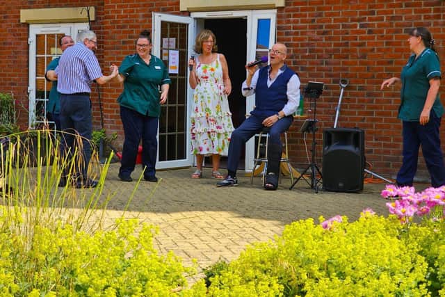 Yvonne and Neil with staff and residents of Elm Bank care home