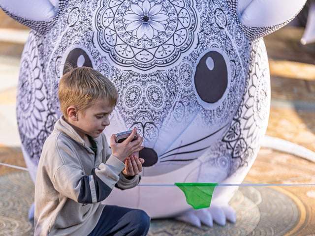 A young attendee with one of the nocturnal inflatables