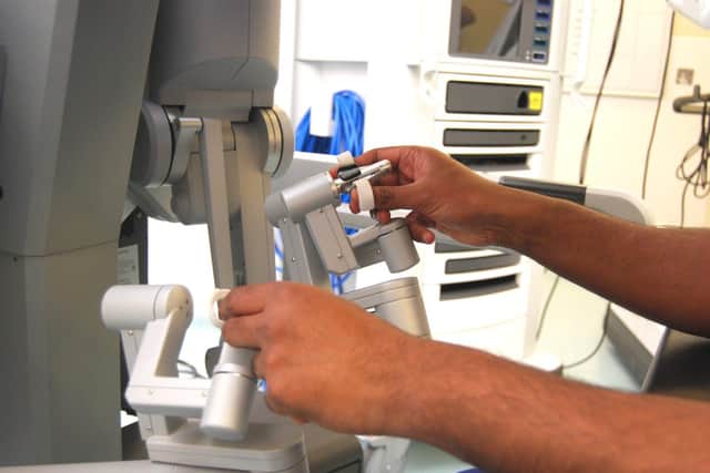 Surgeon operating the robot controls