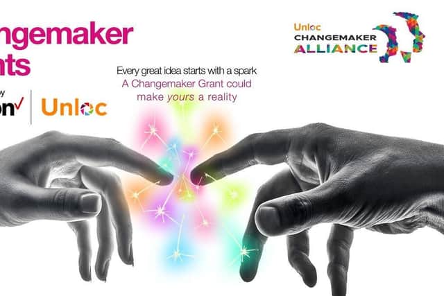 Two hands touching to create a colourful spark. Unloc Changemaker Grants, powered by The Changemaker Alliance and Verizon Business
