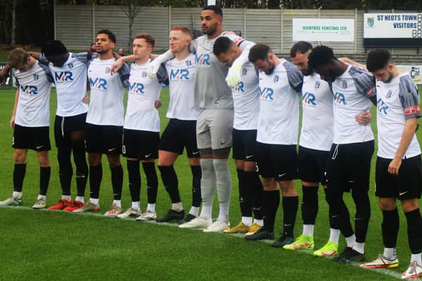 The Corby Town players observed a minute's silence in memory of long-serving club president and secretary Gerry Lucas ahead of last weekend's game at St Neots Town. Picture by David Tilley