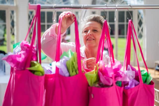 Maxine Lloyd won £1m during her radiotherapy treatment for breast cancer counting the treatment bags