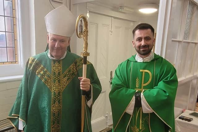 Bishop David and Father Gregory greet parishioners at Holy Trinity