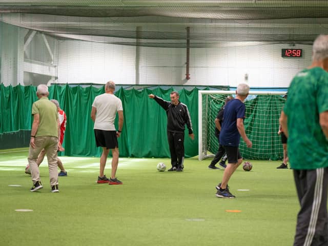 A group of people with Parkinson's playing walking football.