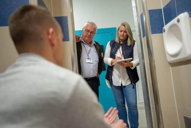 Two volunteers from the Independent Custody Visiting (ICV) scheme visit a detainee at a custody centre