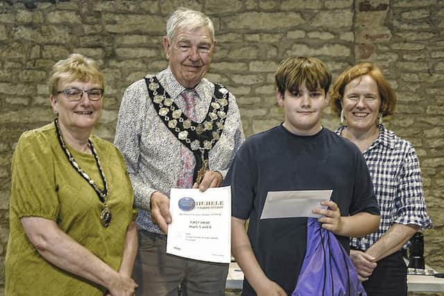 Toby Bailey in Year 6 at Henry Chichele Primary School took first prize in his category with his drawing of the Market Cross, receiving his prizes from Mayor Chris O’Rourke, Kathy Meredith, left, the mayor’s consort, and sponsor Nina Wilson of Wilson Browne Solicitors