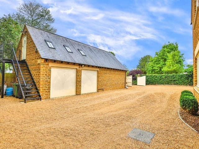 This modern family home is in a picturesque village and shares its boundary with a church.