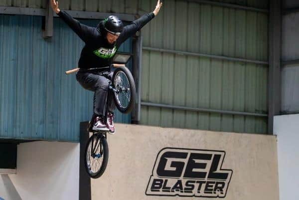 BMX Rider, Charlie Allen, does a ‘no-hander’ at Adrenaline Alley over a freshly painted Gel Blaster logo