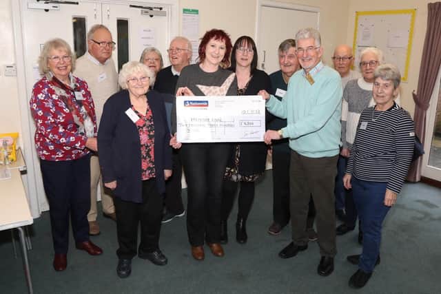 Angie Rose and Debbie Brumby hand the cheque to Dennis Bowden from Kettering Rotary Club, organisers of the Kettering Memory Cafe