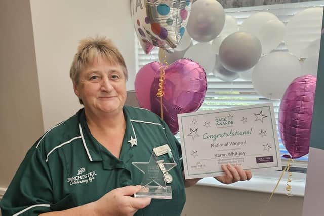 Karen Whitney celebrates with her award.