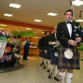 Corby: Asda Corby Burns Night preview Pipe major Robert Muir leads in the haggis at the supermarket. Thursday, 21st January 2010