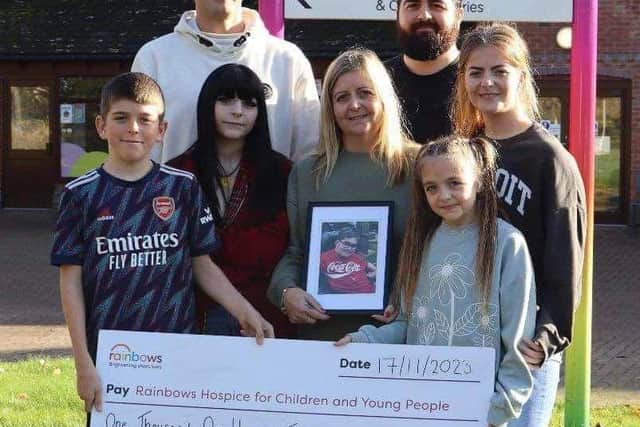 Sam's family with the cheque for Rainbows