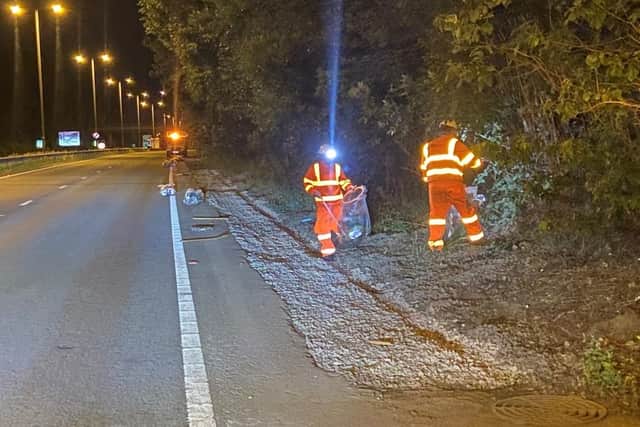 Workers collect litter from alongside the A14 during one of the night-time closures (Pic credit: National Highways)