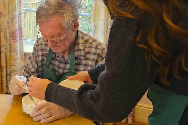 Elm Bank Care Home resident with teachers and pupils of Stone Lodge Therapeutic School decorating cakes and biscuits for Comic Relief.