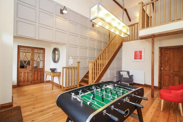 A spacious reception room with space for entertaining or a spot of table football.