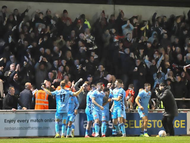 Kettering Town's players and supporters celebrate Luca Miller's extra-time winner in the FA Cup win at Northampton Town (Picture: Peter Short)