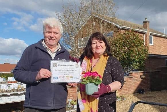 A donation from Jo Becks tipped the total raised to over £20,000. David presented her with a certificate and potted plant to mark it.
