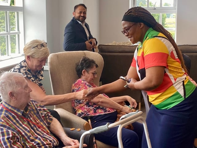 Matter greets residents with traditional handshake and curtsey